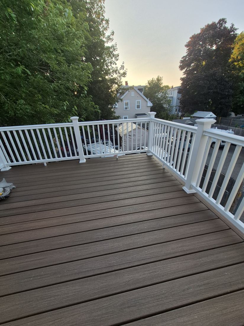 Deck in Lynn, MA after repair with new gray decking and white railing