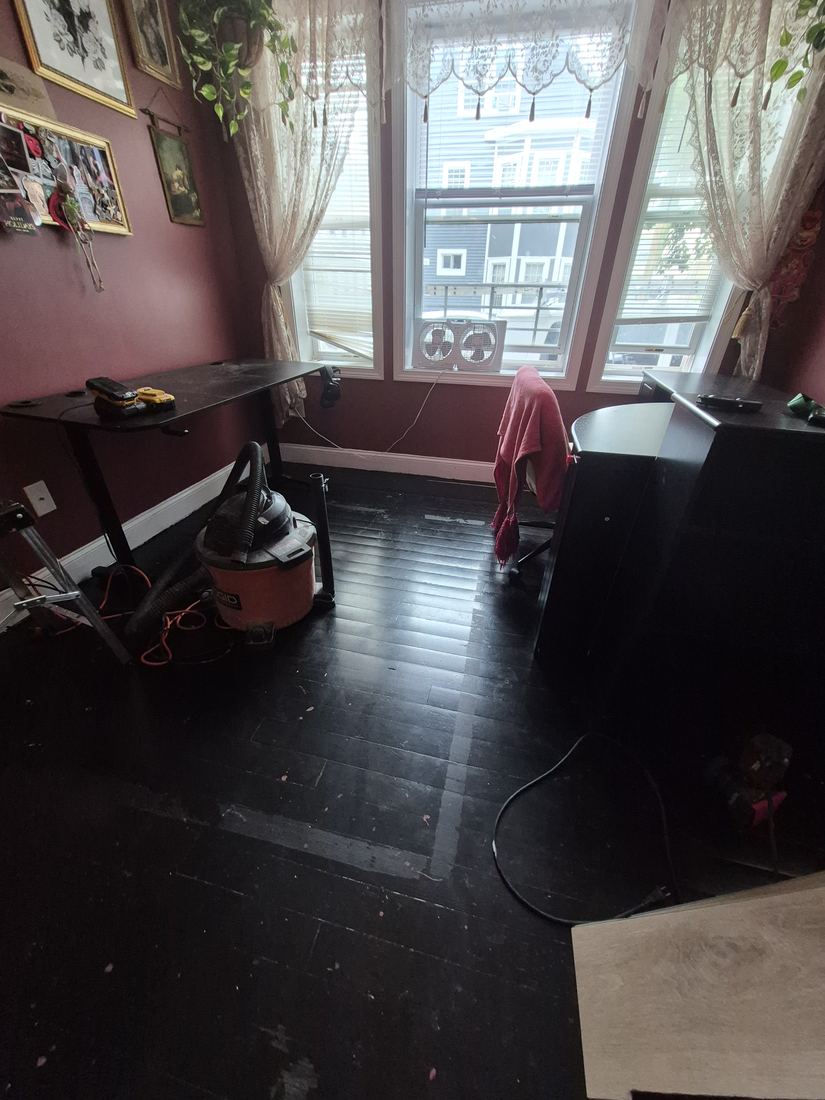 Dining room in Salem, MA before new flooring, with a worn dark floor