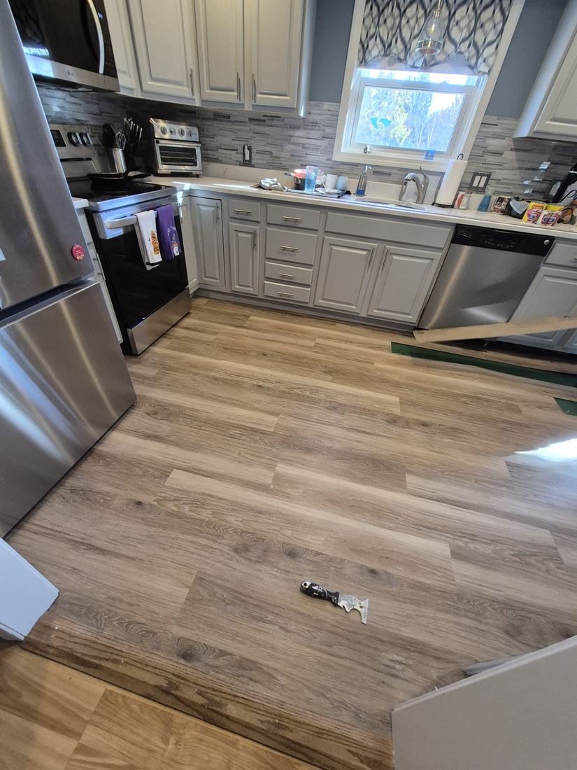 Kitchen in Woburn, MA before new floor with wood-look plank flooring